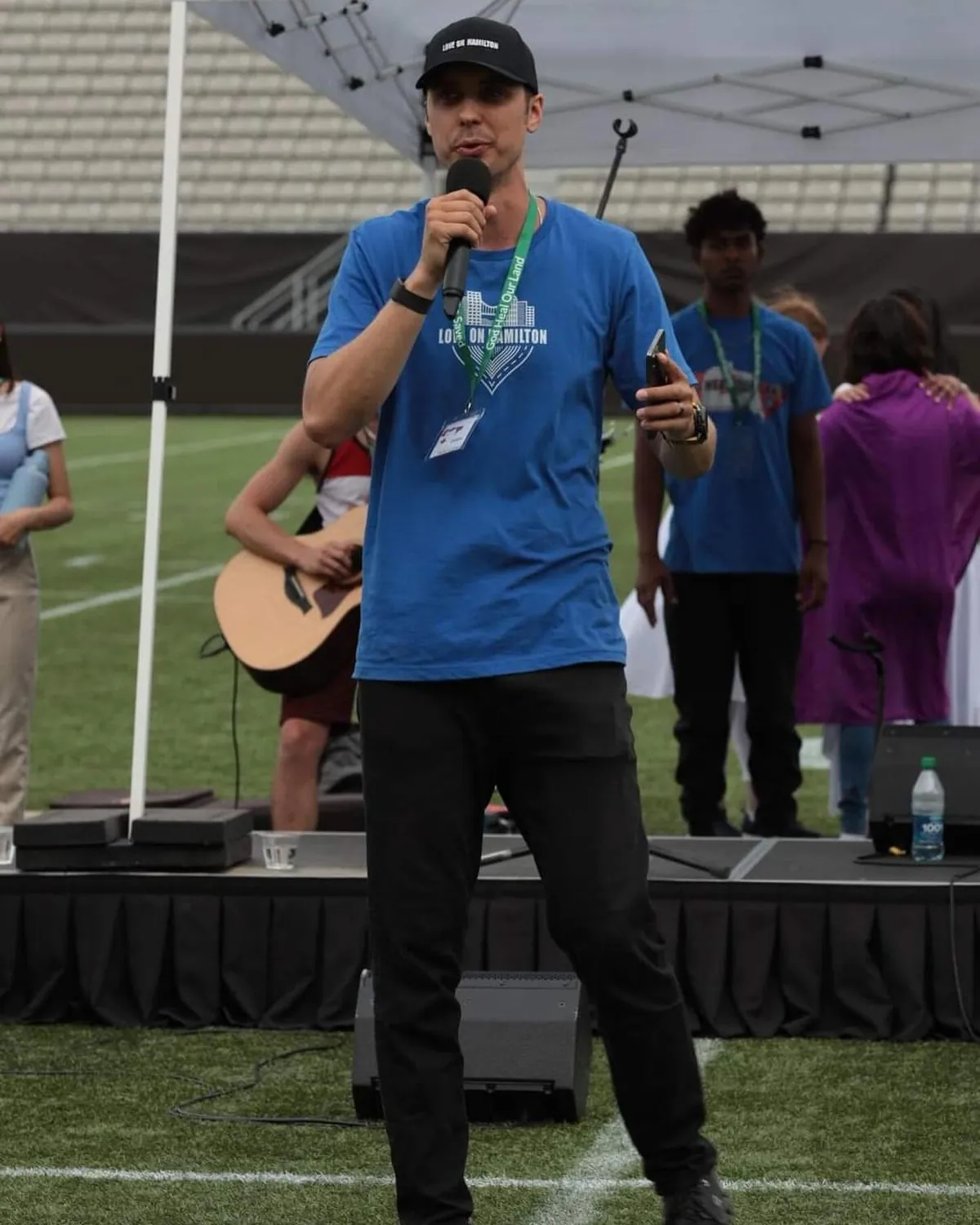 Speaking to people at an outdoor evangelism gathering