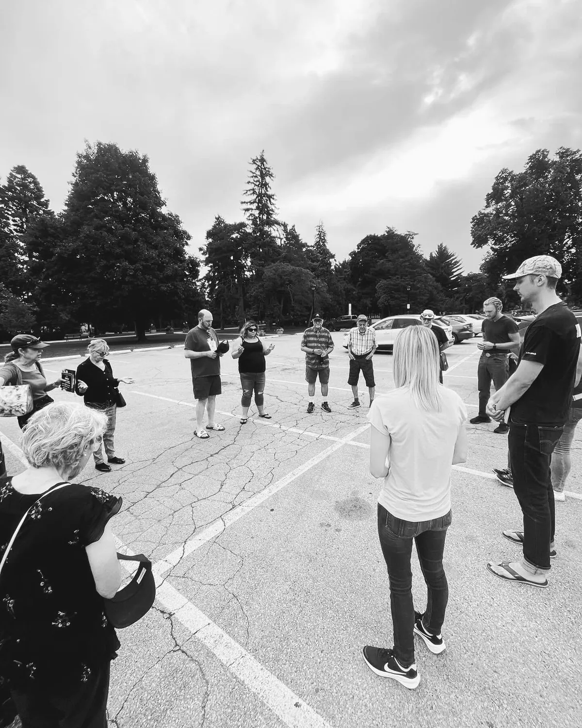 A group gathered in a circle outdoors before a city outreach