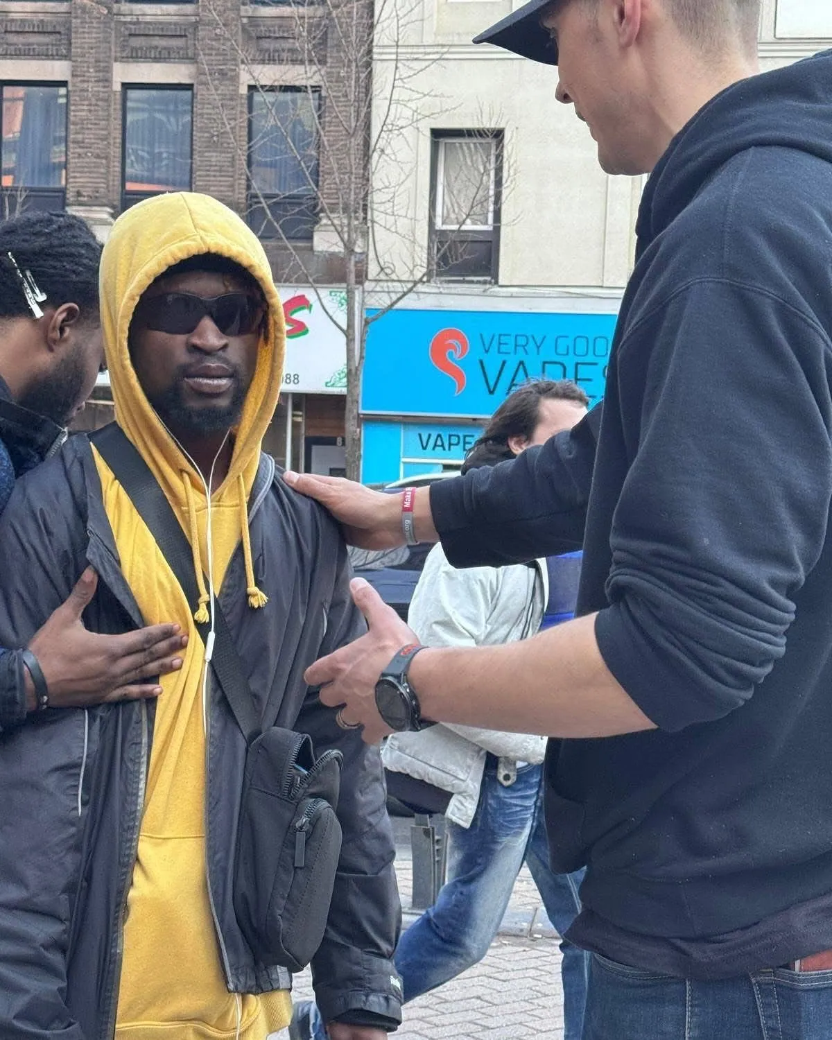 Praying with a man on the street during an evangelism outreach